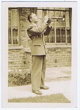 Snapshot Photo of Man Playing a Trumpet on a Sidewalk  